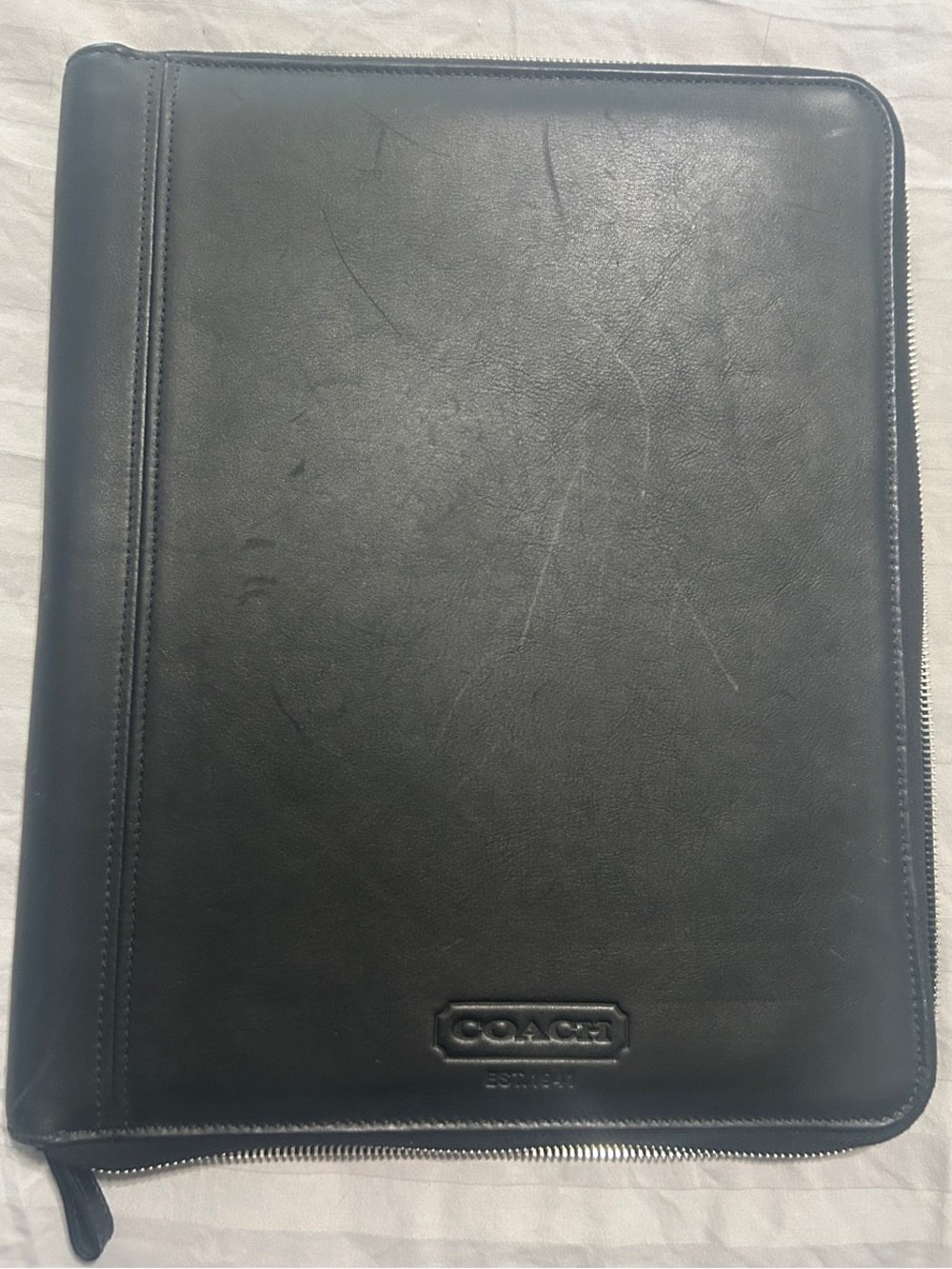 Coach Black Zip Around Portfolio with legal size tablet in the back.